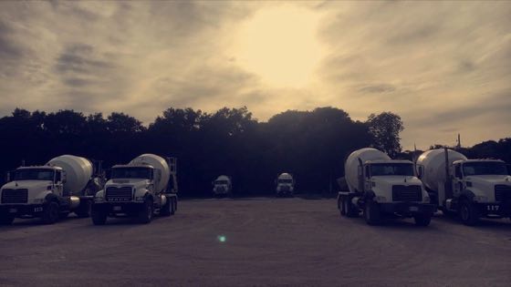 Mixer trucks on the yard at sunset