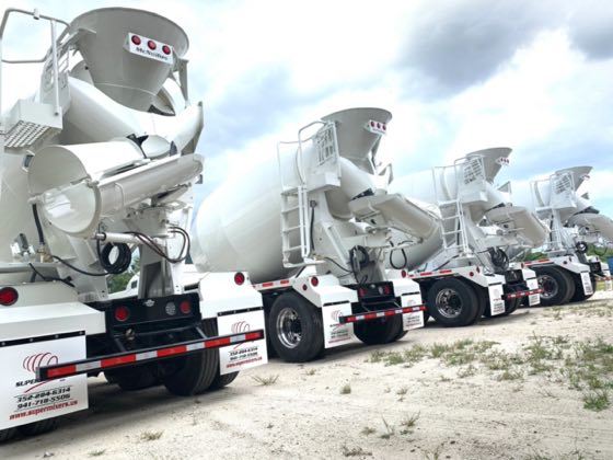 A row of mixer drums under the SuperMixers shed
