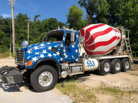 A mixer truck with a stars-and-stripes drum wrap